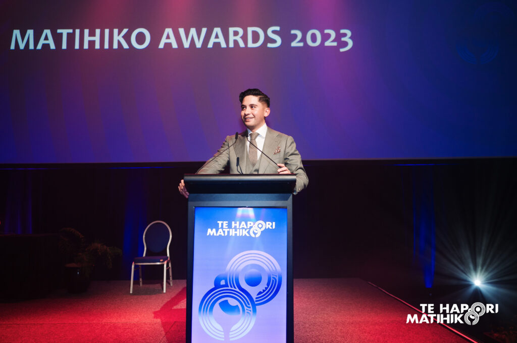 Man standing behind lecturn giving speech at Matihiko Awards 2023